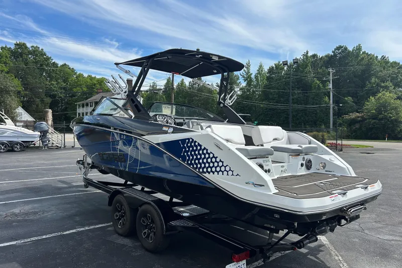 Slide: The Image of 2023 Scarab 255 Wake ID boat on trailer in parking lot, under clear sky. - 4