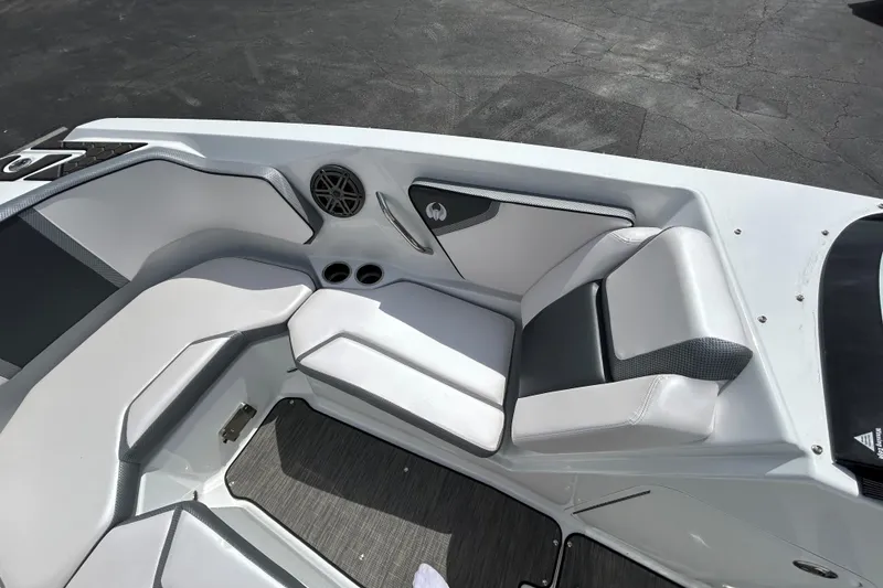 Slide: The Image of 2023 Scarab 255 Wake ID boat interior with white seating and speaker system. - 8