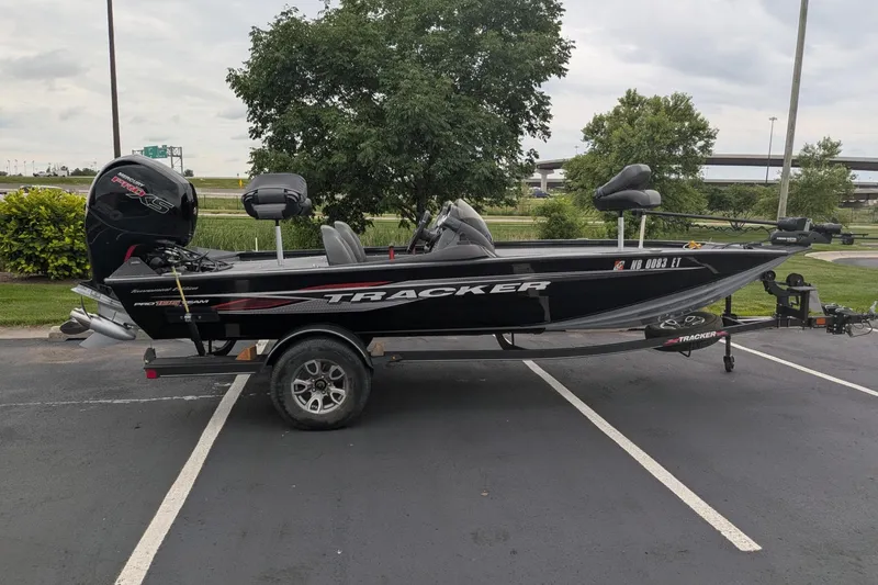 The Image of 2023 Tracker Pro Team 195 TXW Tournament Edition boat parked in a lot, side view. - 0