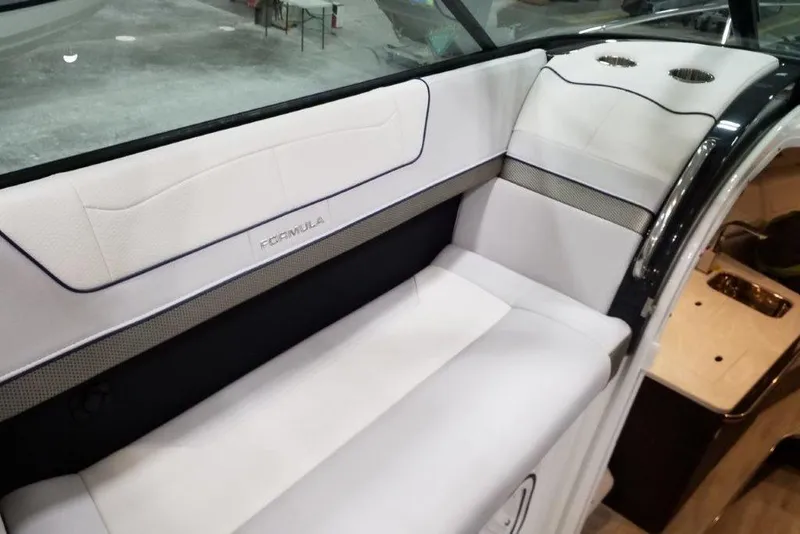 Slide: The Image of 2021 Formula 350 Sun Sport boat interior with white seating and cup holders. - 18