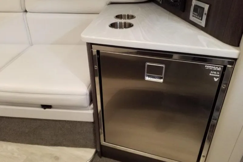 Slide: The Image of Interior of 2021 Formula 350 Sun Sport with stainless steel fridge and white seating. - 22