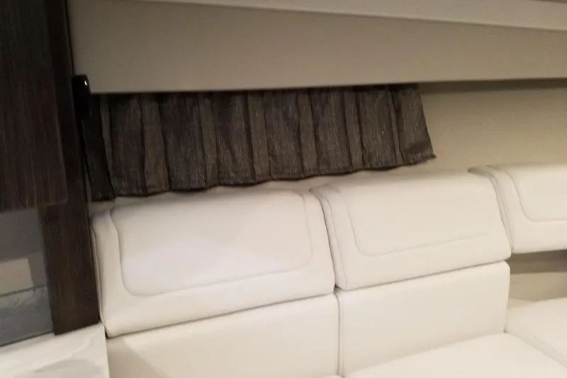 Slide: The Image of Interior of 2021 Formula 350 Sun Sport with white seating and dark curtains. - 25