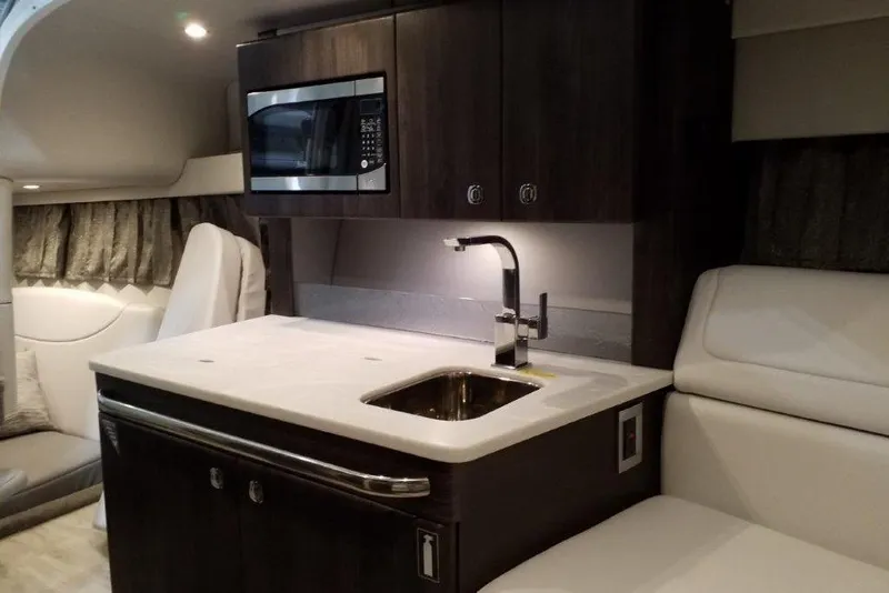 Slide: The Image of Interior of 2021 Formula 350 Sun Sport boat with kitchenette and seating area. - 27