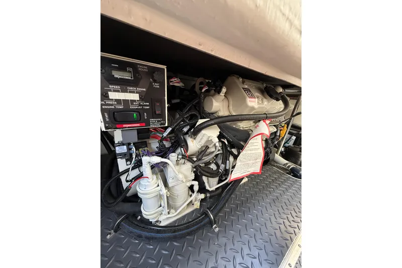 Slide: The Image of Engine compartment of a 2021 Formula 350 Sun Sport boat, showcasing detailed components. - 32