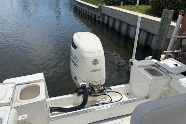 Slide: The Image of 2001 SeaCraft SC 23 Classic boat with Suzuki 250 outboard motor docked by a canal. - 10