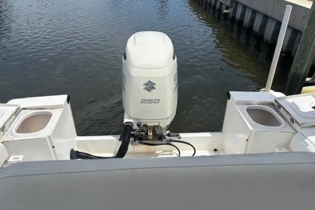 Slide: The Image of SeaCraft SC 23 Classic 2001 boat with Suzuki 250 outboard motor on calm water. - 11