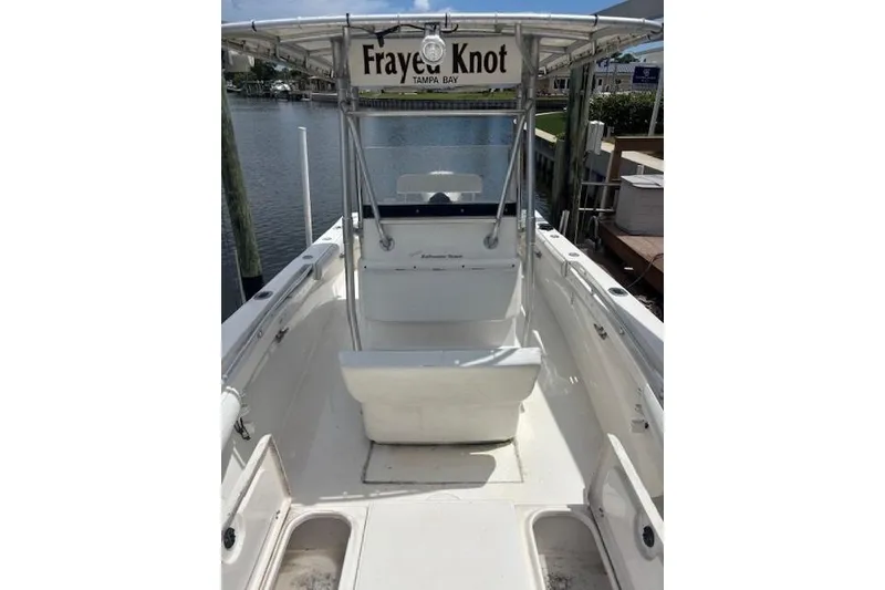 Slide: The Image of 2001 SeaCraft SC 23 Classic boat docked, featuring a center console and canopy. - 12