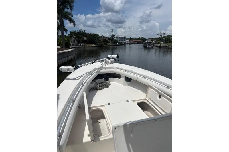 Slide: The Image of 2001 SeaCraft SC 23 Classic boat on a calm waterway under a partly cloudy sky. - 13