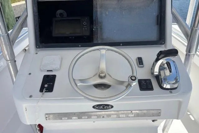 Slide: The Image of Steering console of a 2001 SeaCraft SC 23 Classic boat with navigation equipment. - 15