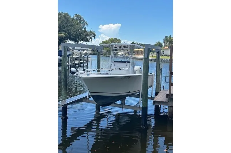 Slide: The Image of 2001 SeaCraft SC 23 Classic boat on lift by waterfront dock. - 3