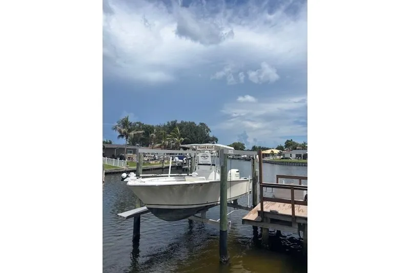 Slide: The Image of 2001 SeaCraft SC 23 Classic boat on lift by waterfront dock. - 4