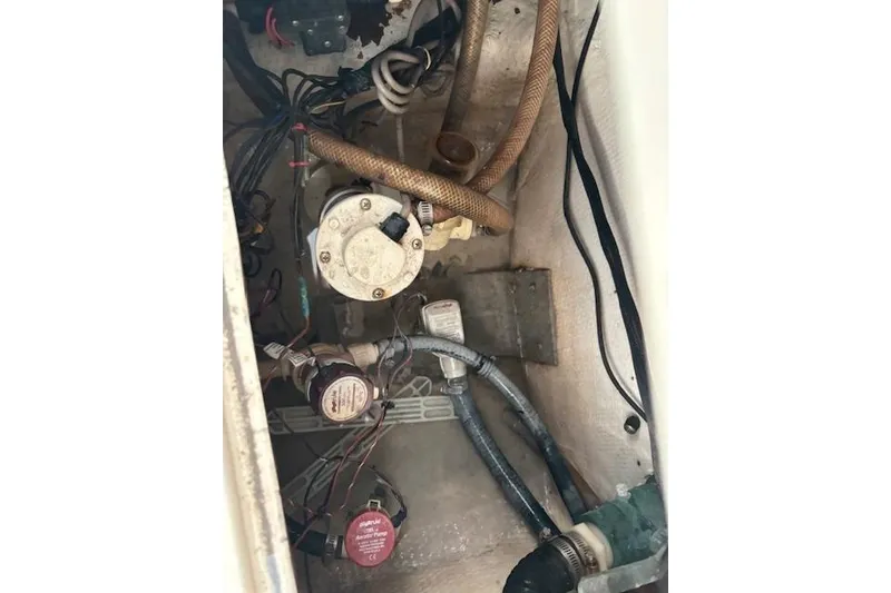 Slide: The Image of Engine compartment of a 2001 SeaCraft SC 23 Classic boat, showing wiring and hoses. - 20