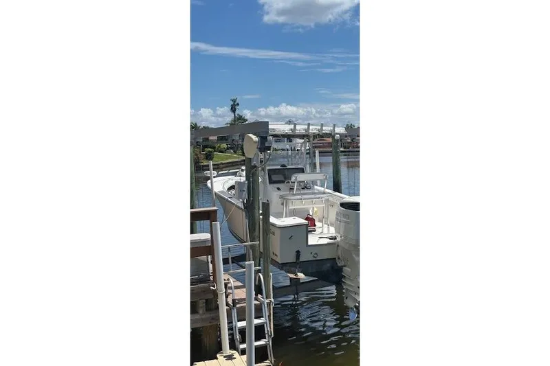 Slide: The Image of 2001 SeaCraft SC 23 Classic boat docked on a sunny day by the water. - 7