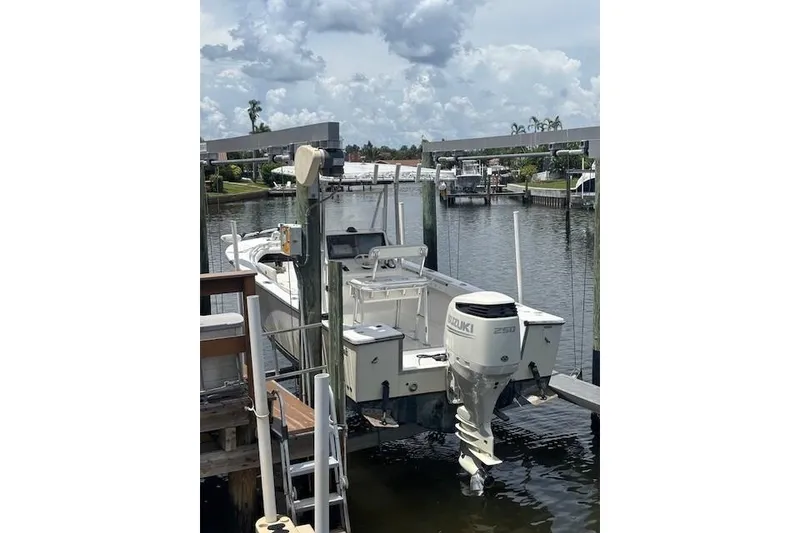 Slide: The Image of 2001 SeaCraft SC 23 Classic boat docked with Suzuki engine, under cloudy sky. - 8