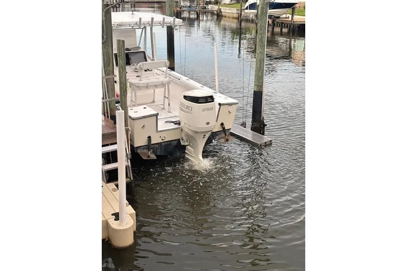 Slide: The Image of 2001 SeaCraft SC 23 Classic boat with Suzuki 250 outboard motor in a marina. - 13
