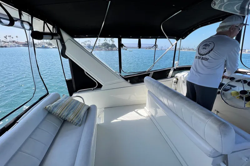 Slide: The Image of 1994 Navigator 4300 yacht interior with helm, seating, and ocean view. - 12