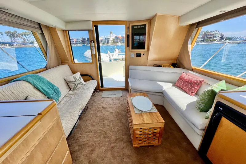 Slide: The Image of Luxurious interior of a 1994 Navigator 4300 yacht with cozy seating and waterfront view. - 15