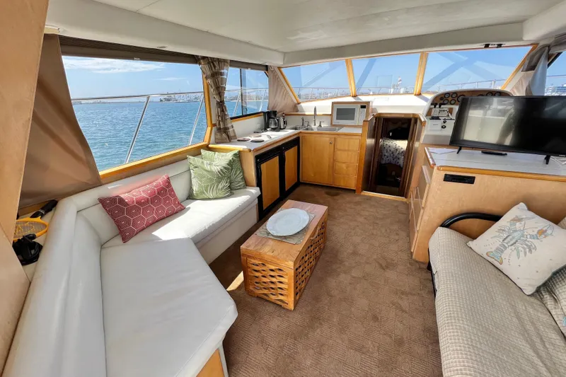 Slide: The Image of Luxurious interior of a 1994 Navigator 4300 yacht with cozy seating and ocean view. - 16