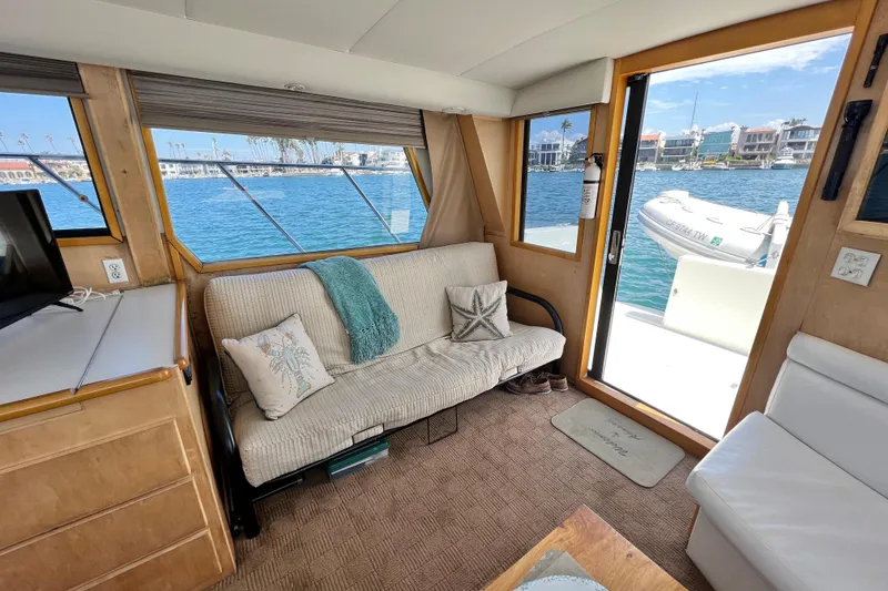 Slide: The Image of Cozy interior of 1994 Navigator 4300 yacht with waterfront view and comfortable seating. - 19