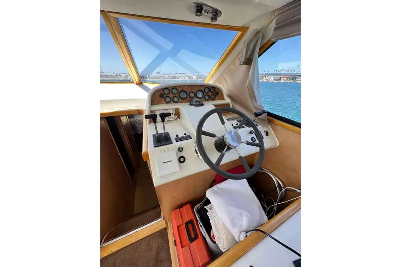 Slide: The Image of Cockpit of a 1994 Navigator 4300 boat with steering wheel and control panel. - 22