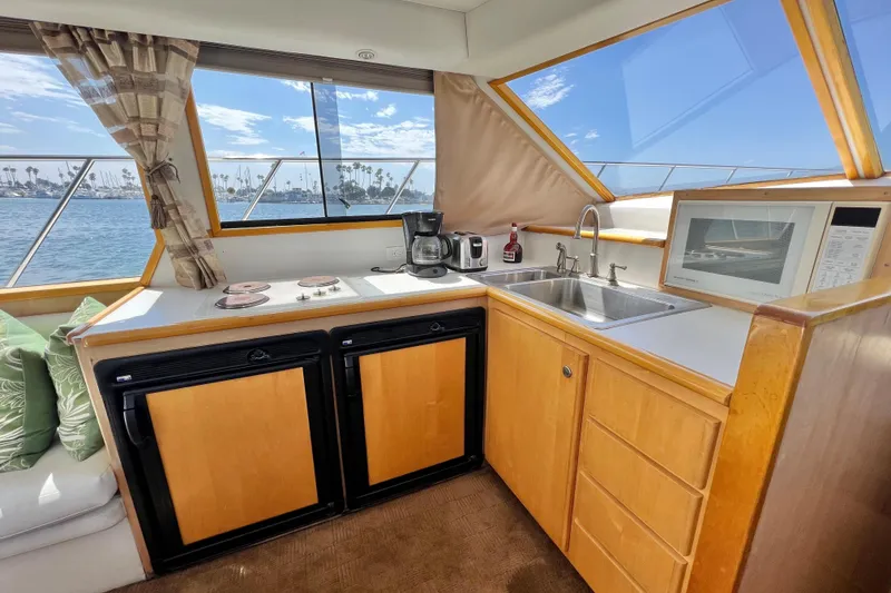 Slide: The Image of Cozy kitchen area on a 1994 Navigator 4300 yacht with ocean view and modern amenities. - 26