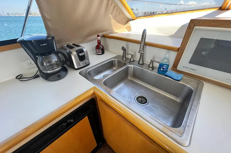 Slide: The Image of Kitchen area on a 1994 Navigator 4300 yacht with sink, coffee maker, and toaster. - 29