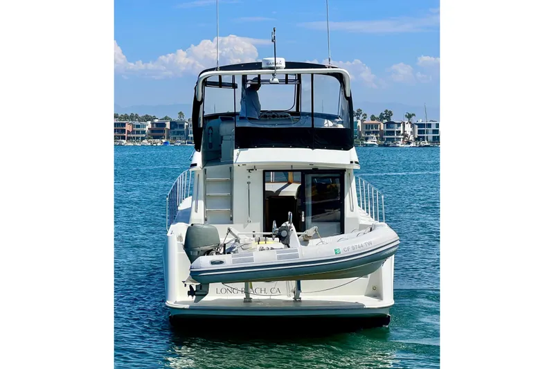Slide: The Image of Navigator 4300 yacht from 1994 docked in Long Beach, CA, with inflatable boat attached. - 3