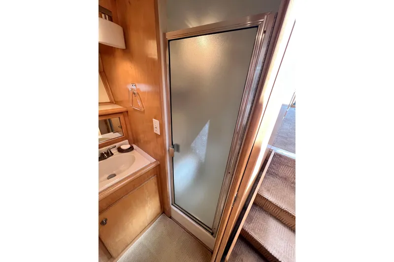 Slide: The Image of Bathroom interior of 1994 Navigator 4300 with sink and frosted glass shower door. - 33