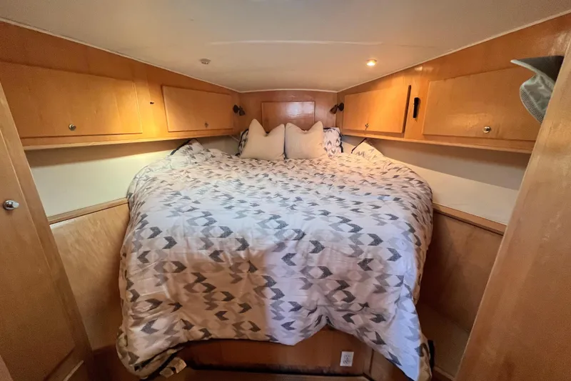 Slide: The Image of Cozy bedroom in 1994 Navigator 4300 yacht with wood cabinets and patterned bedding. - 35