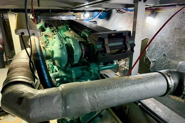 Slide: The Image of Engine room of a 1994 Navigator 4300 yacht, showcasing machinery and piping. - 44