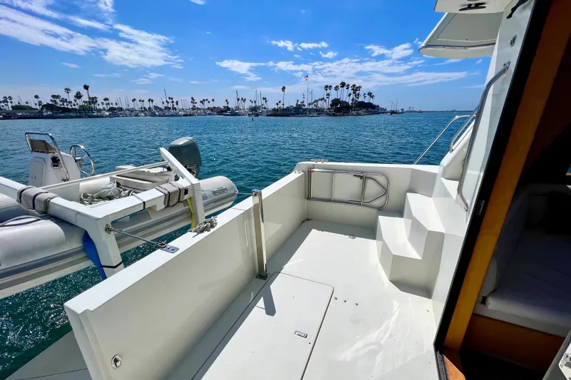 Slide: The Image of Navigator 4300 yacht deck overlooking serene marina with clear blue skies, 1994 model. - 8