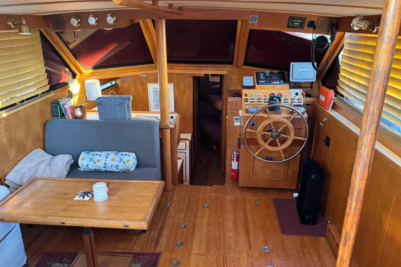 Slide: The Image of Cozy interior of a 1987 President 37 yacht with wooden helm and seating area. - 11
