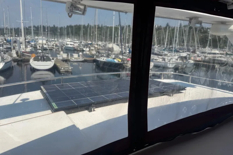 Slide: The Image of View from 1987 President 37 yacht with solar panels, overlooking marina with docked boats. - 71