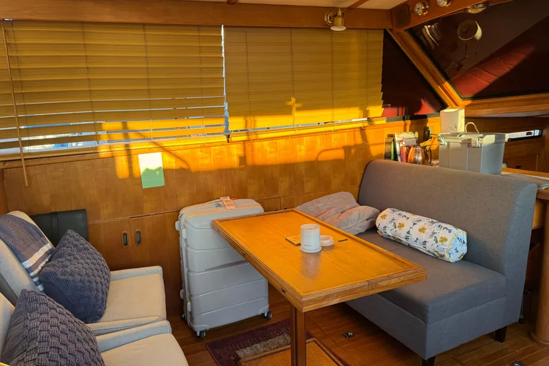 Slide: The Image of Cozy interior of a 1987 President 37 yacht with seating and wooden accents. - 14