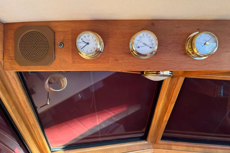 Slide: The Image of Wooden dashboard with brass instruments and speaker on a 1987 President 37 yacht. - 15