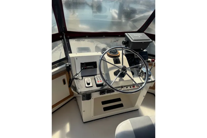 Slide: The Image of 1987 President 37 boat helm with steering wheel, navigation controls, and compass. - 65