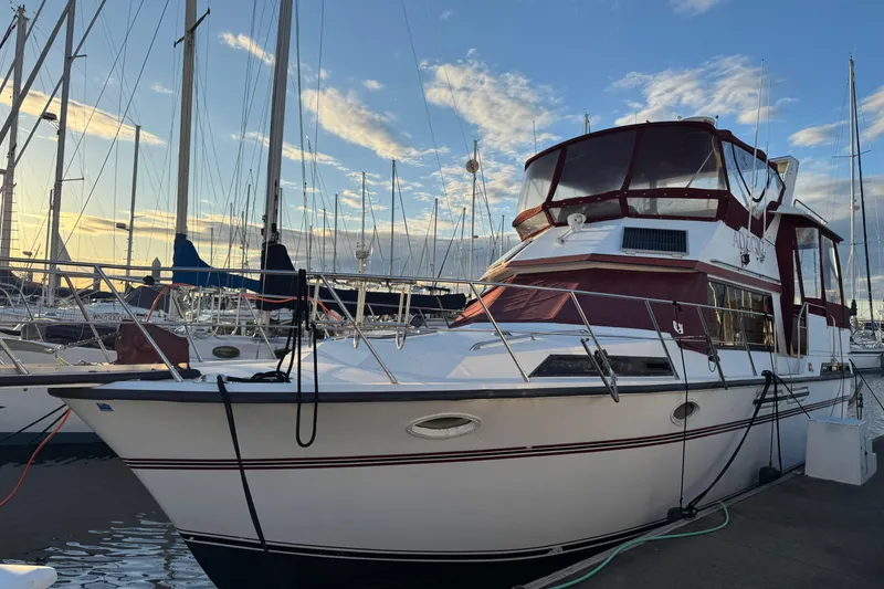 Slide: The Image of 1987 President 37 yacht docked at marina, featuring maroon accents and clear sky backdrop. - 2