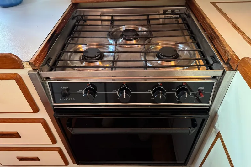 Slide: The Image of Vintage 1987 President 37 stove with three burners and oven in a wooden kitchen setting. - 33
