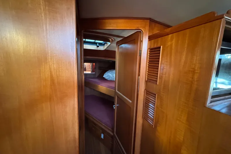 Slide: The Image of Wood-paneled cabin interior of a 1987 President 37 yacht, featuring cozy bunk beds. - 35