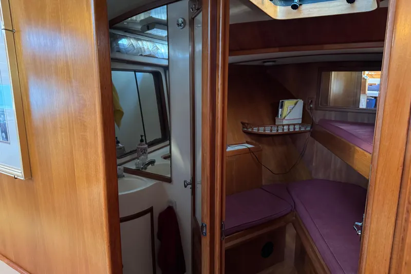 Slide: The Image of Interior of a 1987 President 37 yacht featuring a cozy cabin and bathroom. - 36