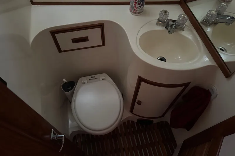 Slide: The Image of Compact bathroom in a 1987 President 37 yacht, featuring a toilet and sink. - 37