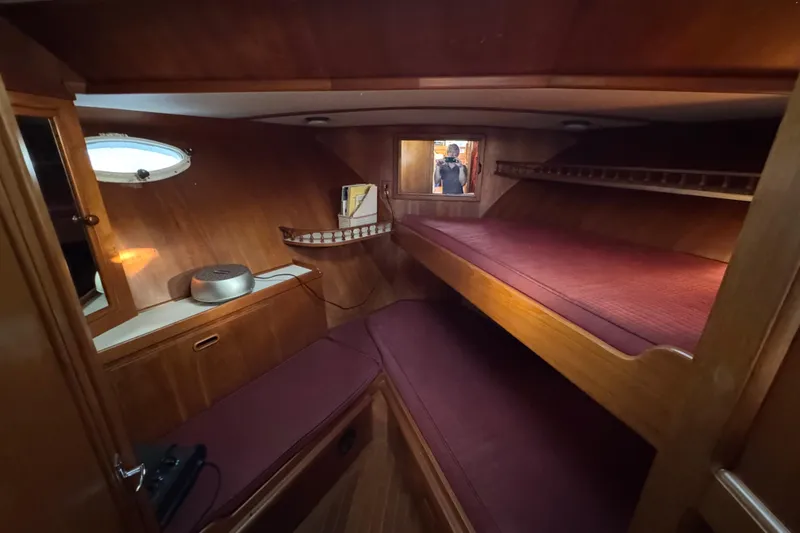Slide: The Image of Cozy cabin interior of 1987 President 37 yacht with wooden furnishings and bunk beds. - 39