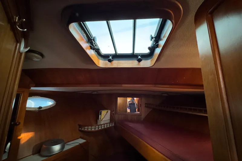 Slide: The Image of Cozy cabin interior of a 1987 President 37 yacht with wooden furnishings and skylight. - 40
