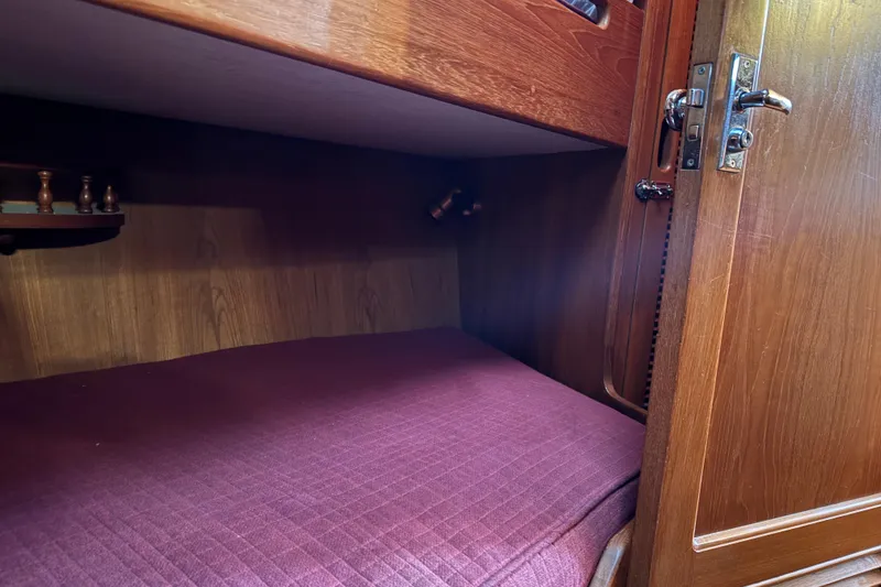 Slide: The Image of Cozy wooden cabin interior with a purple mattress, featuring vintage design elements. - 42