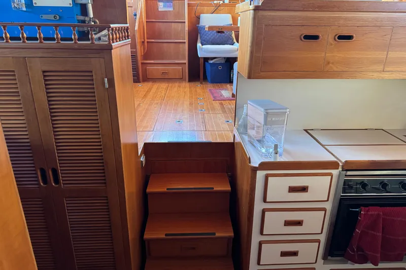 Slide: The Image of Interior of a 1987 President 37 yacht with wooden cabinetry and compact kitchen. - 44