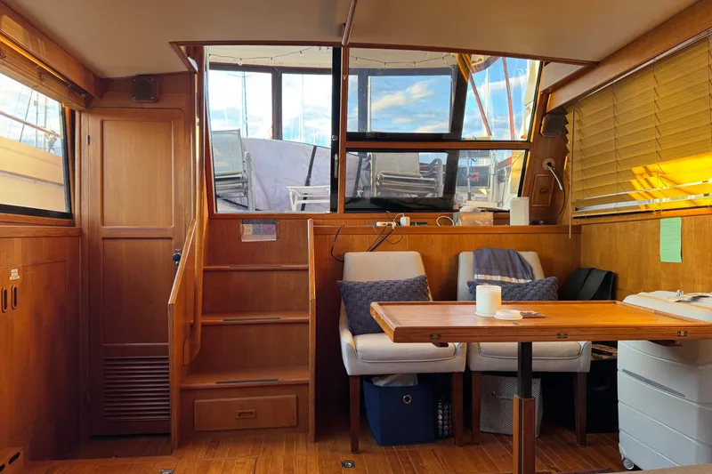 Slide: The Image of Interior of a 1987 President 37 yacht with wooden furnishings and cozy seating area. - 45