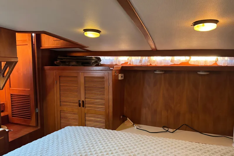 Slide: The Image of Cozy cabin interior of 1987 President 37 yacht with wooden furnishings and soft lighting. - 50
