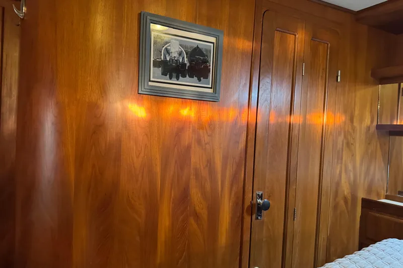 Slide: The Image of Wood-paneled room with framed artwork, featuring warm lighting and a closed door. - 54