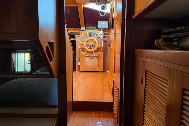 Slide: The Image of Interior of a 1987 President 37 yacht with wooden helm and cozy cabin. - 60