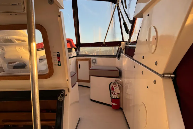 Slide: The Image of Interior of a 1987 President 37 boat with seating and a fire extinguisher. - 62